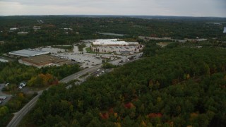 AX152_031 - 5.5K aerial stock footage flying over colorful trees, approaching a Target, autumn, Hooksett, New Hampshire