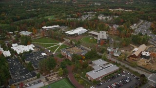 AX152_033E - 5.5K aerial stock footage flying over Southern New Hampshire University, pan left, autumn, Hooksett, New Hampshire