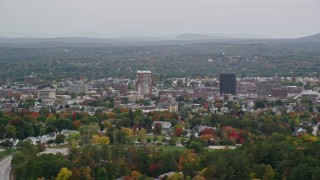 AX152_042E - 5.5K aerial stock footage flying by downtown office towers, overcast skies, autumn, Manchester, New Hampshire
