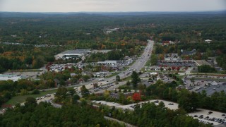 AX152_054 - 5.5K aerial stock footage flying by car dealership, strip mall, Nashua Road, autumn, Londonderry, New Hampshire