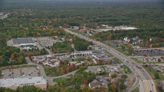 AX152_054E - 5.5K aerial stock footage flying by car dealership, strip mall, Nashua Road, autumn, Londonderry, New Hampshire