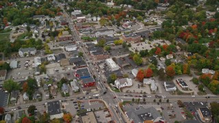 AX152_056E - 5.5K aerial stock footage flying by homes, downtown area, colorful foliage in autumn, Derry, New Hampshire