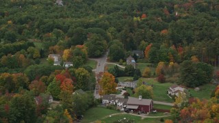 AX152_066 - 5.5K aerial stock footage flying by rural homes, colorful foliage in autumn, Windham, New Hampshire