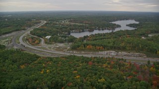 AX152_068 - 5.5K aerial stock footage flying by Interstate 93, Cobbetts Pond, autumn, Windham, New Hampshire