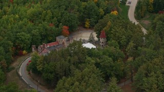 AX152_069 - 5.5K aerial stock footage flying away from Searles Castle, trees, autumn, Windham, New Hampshire