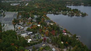AX152_070 - 5.5K aerial stock footage orbiting Canobie Lake Park, colorful foliage in autumn, Salem, New Hampshire