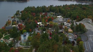 AX152_073 - Aerial stock footage of 5.5K aeria video orbiting colorful foliage, Canobie Lake Park, autumn, Salem, New Hampshire