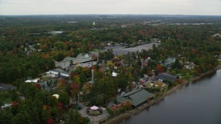 AX152_076 - 5.5K aerial stock footage orbiting Canobie Lake Park, overcast sky, autumn, Salem, New Hampshire