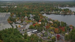 AX152_076E - 5.5K aerial stock footage orbiting Canobie Lake Park, overcast sky, autumn, Salem, New Hampshire