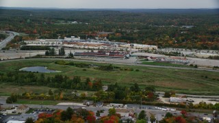 AX152_080 - 5.5K aerial stock footage flying by Rockingham Park, colorful foliage in autumn, overcast, Salem, New Hampshire