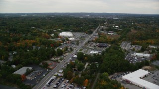 AX152_083 - 5.5K aerial stock footage flying over Broadway, approaching stores and tilt down, Salem, New Hampshire
