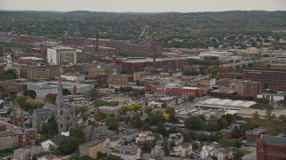 AX152_087 - 5.5K aerial stock footage flying by church, factories, smoke stacks, autumn, overcast, Lawrence, Massachusetts