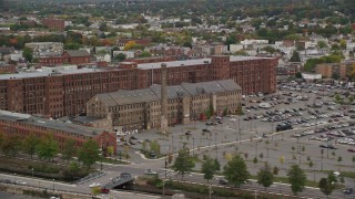 AX152_094 - 5.5K aerial stock footage flying by factories, smoke stacks, colorful foliage, autumn, Lawrence, Massachusetts