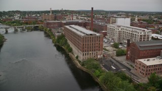 AX152_095 - 5.5K aerial stock footage flying over Duck Bridge, pan right by factories, autumn, Lawrence, Massachusetts