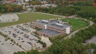 AX152_166 - 5.5K aerial stock footage orbiting away from an office building and parking lot, autumn, Burlington, Massachusetts