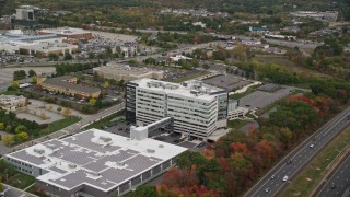 AX152_167 - 5.5K aerial stock footage flying away from office buildings and parking lots, autumn, Burlington, Massachusetts