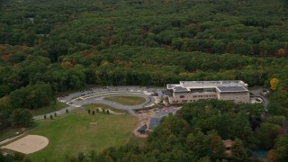 AX152_168 - 5.5K aerial stock footage approaching Joseph Estabrook Elementary School, autumn, Lexington, Massachusetts