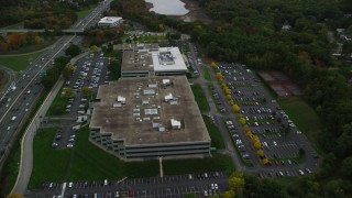 AX152_173 - 5.5K aerial stock footage flying over Interstate 95, approaching office buildings, autumn, Waltham, Massachusetts