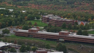 AX152_175 - 5.5K aerial stock footage flying by office buildings, colorful foliage, autumn, overcast, Waltham, Massachusetts