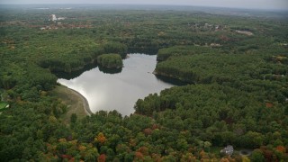 AX152_176 - 5.5K aerial stock footage flying by Weston Reservoir, colorful foliage, autumn, Weston, Massachusetts