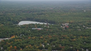 AX152_177 - 5.5K aerial stock footage approaching Lake Waban, Green Hall, autumn, overcast, Wellesley College, Massachusetts