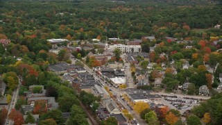 AX152_186 - 5.5K aerial stock footage flying by church and shops along busy streets in autumn, Wellesley, Massachusetts