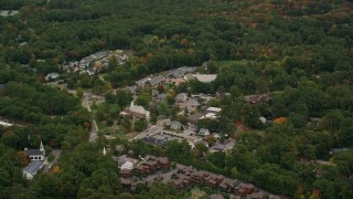 AX152_188E - 5.5K aerial stock footage flying by Dover City Hall, small town, autumn, Dover, Massachusetts