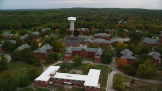 AX152_195 - 5.5K aerial stock footage orbiting Medfield State Hospital among fall foliage, autumn, Medfield, Massachusetts