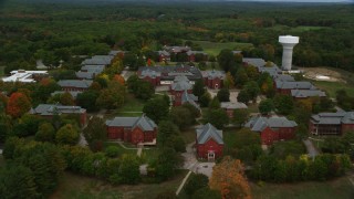 AX152_203 - 5.5K stock footage aerial video flying over Medfield State Hospital and trees in autumn, Medfield, Massachusetts