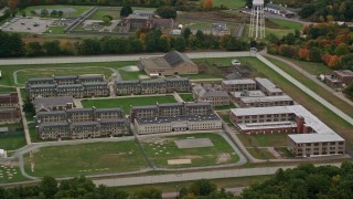AX152_212 - 5.5K aerial stock footage approaching Massachusetts Correctional Institution at Norfolk, surrounded by fall foliage, Massachusetts