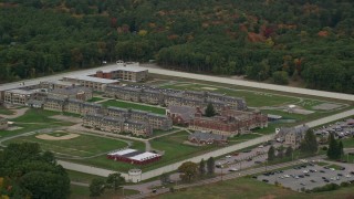 AX152_226E - 5.5K aerial stock footage of a high approach toward Massachusetts Correctional Institution at Norfolk, and fall foliage, Massachusetts