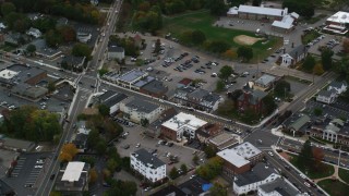 AX152_231 - 5.5K stock footage aerial video tilting down on shops and Main Street, Walpole, Massachusetts