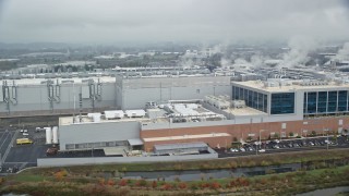 AX153_001 - 5.5K aerial stock footage of the Intel manufacturing plant at Intel Ronler Acres Campus and low clouds, autumn, Hillsboro, Oregon