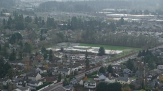 AX153_003 - 5.5K aerial stock footage flying by an elementary school in autumn, Beaverton, Oregon