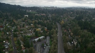 AX153_010 - 5.5K aerial stock footage flying over residential area toward a hilltop preschool on a cloudy day, autumn, Portland, Oregon