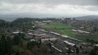 AX153_011E - 5.5K aerial stock footage flying over football fields and high school, autumn, Portland, Oregon
