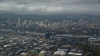 AX153_023 - 5.5K stock footage aerial video flying over office buildings and high-rises with view of Downtown Portland with clouds, Oregon