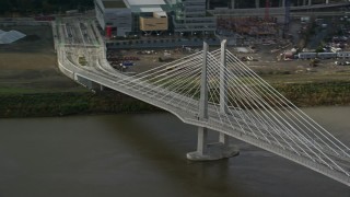 AX153_035 - 5.5K aerial stock footage flying away from Tilikum Crossing, cable stayed bridge, Downtown Portland, Oregon