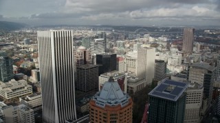 AX153_038E - 5.5K aerial stock footage flying over KOIN Center and Wells Fargo Bank Center among city buildings; Downtown Portland, Oregon