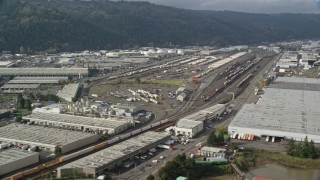 AX153_060 - 5.5K aerial stock footage passing a train yard, Northwest Portland, Oregon