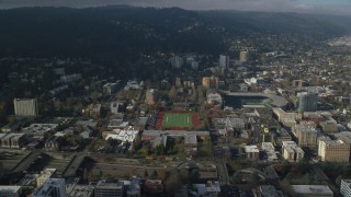 AX153_086 - 5.5K stock footage aerial video flying over Lincoln High School sports fields to approach apartment buildings in Goose Hollow, Portland, Oregon