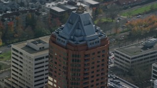 AX153_117E - 5.5K aerial stock footage of steam venting from the roof of KOIN Center in Downtown Portland, Oregon
