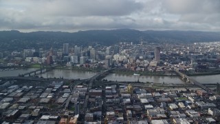 AX153_127E - 5.5K aerial stock footage of bridges spanning Willamette River and skyscrapers in Downtown Portland, Oregon