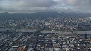 AX153_128 - 5.5K aerial stock footage from across the Willamette River of bridges and Downtown Portland, Oregon