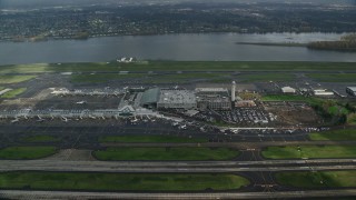 AX153_133E - 5.5K aerial stock footage approaching Portland International Airport in Oregon and tilt down to terminals