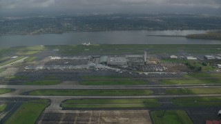 AX153_134 - 5.5K aerial stock footage approaching Portland International Airport in Oregon and tilt down to terminals