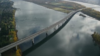 AX153_138E - 5.5K aerial stock footage of I-205 Bridge spanning Columbia River in Vancouver, Washington