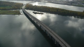 AX153_140 - 5.5K aerial stock footage of the I-205 Bridge spanning the Columbia River in Vancouver, Washington