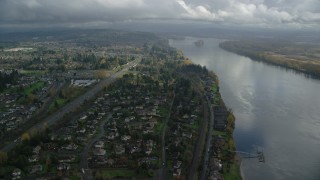 AX153_142 - 5.5K aerial stock footage approaching Highway 14 and fly over suburban homes on the Columbia River in Vancouver, Washington