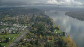 AX153_144 - 5.5K aerial stock footage flying over riverfront homes between Highway 14 and the Columbia River in Vancouver, Washington